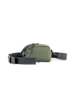 a green fanny bag with black straps on the bottom and an adjustable belt around it