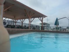 an empty swimming pool in front of some buildings