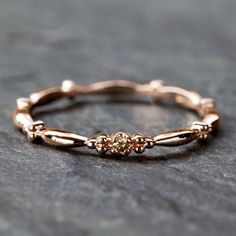 * Band width: ≈1.75mm * Setting size: ≈2mm * Diamond size: ≈1.5mm (≈0.02ct) * Material: 14k solid gold * Made of 100% recycled precious metal and ethically sourced gemstone * Comes in a gift box with a bow ready for gifting * Handmade with love and great care in New York *Please make sure you check the size using Ring Size Guide. *Due to the nature of handmade pieces each jewelry might have slight variations. Colors may look slightly different depending on screen and lighting. Items might appear 14k Rose Gold Dainty Stackable Promise Rings, Fine Jewelry Rose Gold Diamond Stackable Rings, Fine Jewelry Diamond Stackable Rings In Rose Gold, Rose Gold Diamond Stackable Rings Fine Jewelry, Diamond Stackable Rings With Bezel Setting For Promise, Dainty Eternity Band With Single Cut Diamonds, Dainty Rose Gold Diamond Ring, Rose Gold Stackable Rings With Prong Setting, Rose Gold Stackable Promise Rings With Single Cut Diamonds