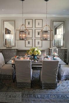 the dining room table is set with four chairs, and there are pictures on the wall behind it