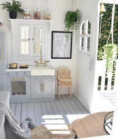 a kitchen with white walls and wooden floors