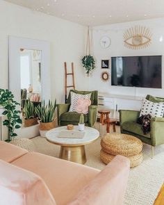 a living room filled with furniture and a flat screen tv mounted to the side of a wall