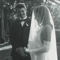 a bride and groom standing next to each other