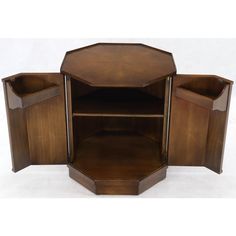 an octagonal wooden cabinet with two open shelves