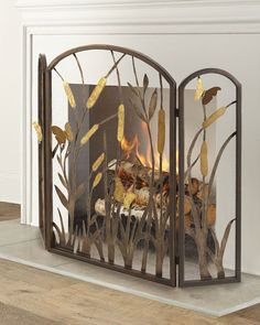 a fire place with an iron screen in the middle