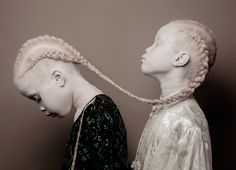 two women with braids standing next to each other