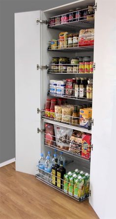 an organized pantry is shown in the corner of a room with wood floors and white walls