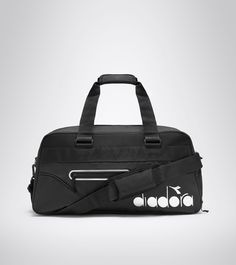 a black duffel bag with white circles on the front and side zippers,