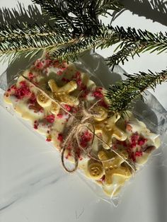 some kind of food sitting on top of a piece of wax paper next to a pine tree