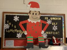 a bulletin board with an elf standing in front of it