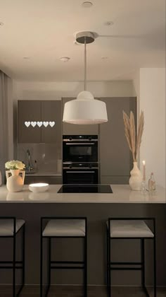 a kitchen with an island and stools in it