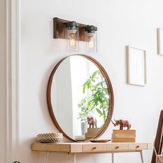 a mirror on the wall above a desk with a wooden table and chair next to it