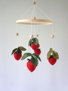 a mobile with strawberries hanging from it