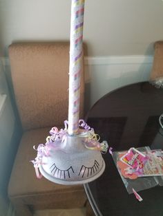 a birthday cake shaped like a unicorn's head on top of a small table