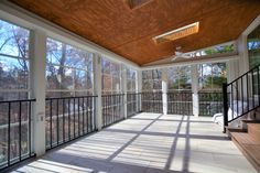 the sun shines through the windows in an enclosed porch