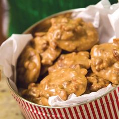 a tin filled with cookies covered in caramel icing next to a donut