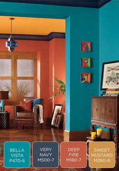 a living room with blue walls and wood flooring in the center is painted bright orange