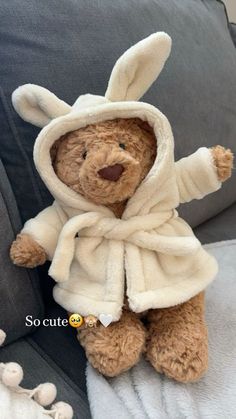 a brown teddy bear wearing a white robe