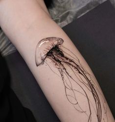 a jellyfish tattoo on the left arm