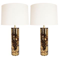 a pair of table lamps sitting next to each other on top of a white floor