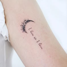 a woman's arm with a tattoo that reads, i love you to the moon and back