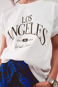 Give yourself some love in this comfy and trendy, which is made in Italy. You can wear casually with jeans or shorts. In our photos, we style this tee with our Relaxed Leg Pant in Blue Leopard Print. It boasts of shorts sleeves, a crew neck, a relaxed fit, and “Los Angeles West Coast” text on the front. The fabric is made from 100% Cotton. The model is 5’8” with measurements of 33-24-35. One size fits all. T Shirt Branca, Blue Leopard Print, Blue Leopard, Home T Shirts, Fit Style, Shirt Collar, Casual Wardrobe, White T, West Coast