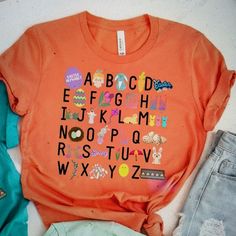 Easter Teacher Alphabet Shirt - Teacher Easter Shirt - Easter Shirt For Teachers - Teacher Easter - Happy Easter Shirt Color: Orange Size: Large Bought The Wrong Size For My Daughter - Brand New Never Worn Bundle To Automatically Save 15% On Three Items! Bundle Multiple Likes And I Will Send A Special Offer! Great Reviews Lightning Fast Shipping Non-Smoking Home No Trades Please Cute Multicolor Printed Shirt, Fun Printed Spring Shirt, Fun Orange T-shirt For Spring, Playful Crew Neck Shirt For Spring, Playful Crew Neck Spring Shirt, Spring Crew Neck Playful Shirt, Spring Playful Crew Neck Shirt, Spring Orange Shirt With Graphic Print, Cute Multicolor Shirt With Letter Print