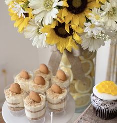 cupcakes and sunflowers are on a table