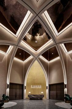 the interior of a building with an arched ceiling and marble flooring is lit by recessed lights