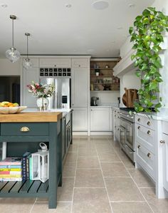 a kitchen with white cabinets and green island