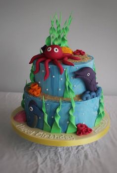 a three tiered cake decorated with sea animals