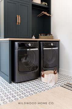 a washer and dryer in a laundry room next to a cabinet with open shelves