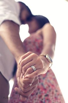 a man and woman holding hands while standing next to each other