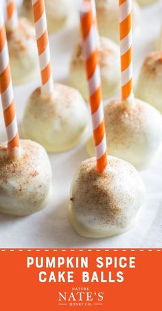 pumpkin spice cake balls with orange and white striped paper straws on top are ready to be eaten