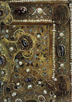 an intricately decorated book with pearls and other things on it's front cover