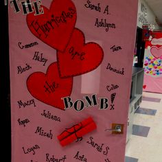 a bulletin board with writing on it and two hearts attached to the back of it