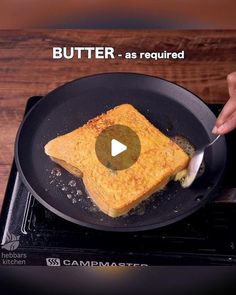 someone is frying food in a skillet on the stove with a spatula