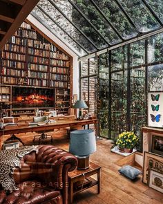 a living room filled with lots of furniture and bookshelves next to a fire place