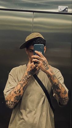 a man taking a selfie in front of a mirror with his cell phone up to his face