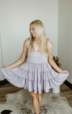 Step into carefree vibes with the Sundown Serenade Tiered Babydoll Dress. Made from textured crepe fabric, this boho-inspired dress features tiered ruffles for a playful, flowy silhouette that dances with every step. The adjustable tie straps allow for a customizable fit, making it perfect for sunny beach days or warm nights out. With its wide bottom sweep, this dress adds an effortlessly feminine touch to any occasion. Whether you're strolling through a farmers' market or heading to a casual su Breezy Dress With Ruffled Straps For Brunch, Flowy Sundress With Ruffled Straps For Brunch, Breezy Brunch Dress With Ruffled Straps, Cute Summer Dresses With Tiered Skirt, Flowy Ruffle Dress With Ruffled Straps For Beach, Flowy Breezy Sundress With Ruffles, Flowy Ruffled Skirt Mini Dress For Vacation, Spring Flowy Sundress With Ruffles, Summer Tiered Ruffle Dress For Garden Party