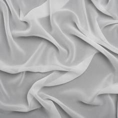 Keep cool in this White Polyester Chiffon, featuring a dry hand and fluid drape.Suggested Projects:  Dresses, Skirts, Shirts, BlousesContent:  100% PolyesterStretch:  NoneOpacity:  SheerThis white chiffon feels like a whisper against your skin. With a dry hand and fluid drape, design eye-catching overlays for evening gowns, flowing summer dresses, scarves, skirts, and sheer blouses. Sheer and without stretch, a lining may be added for opacity and structure where desired—or use this chiffon as a lining! Sheer Blouses, Flowing Summer Dresses, Mood Fabrics, White Chiffon, Famous Designers, Keep Cool, Dry Hands, Fabric Online, Fashion Fabric