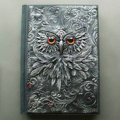 an intricately designed book with orange eyes