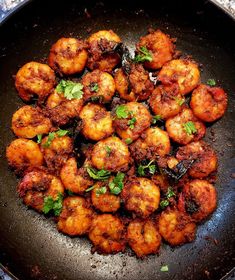 fried food in a frying pan with parsley on top