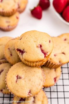 several muffins stacked on top of each other with strawberries in the background