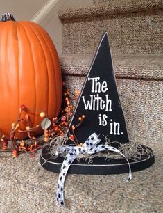 a halloween decoration with a witches hat and pumpkin