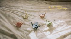 four origami cranes on a bed with the words do the reason someone will tell you