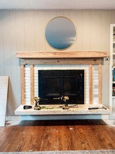 a living room with a fire place in the center and shelves on either side,