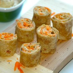 there are carrots wrapped in bread on the cutting board