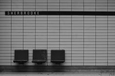 three black and white benches sitting in front of a tiled wall with the word sherbroke written on it