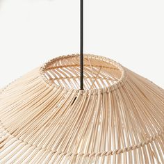 a bamboo lamp shade hanging from a ceiling